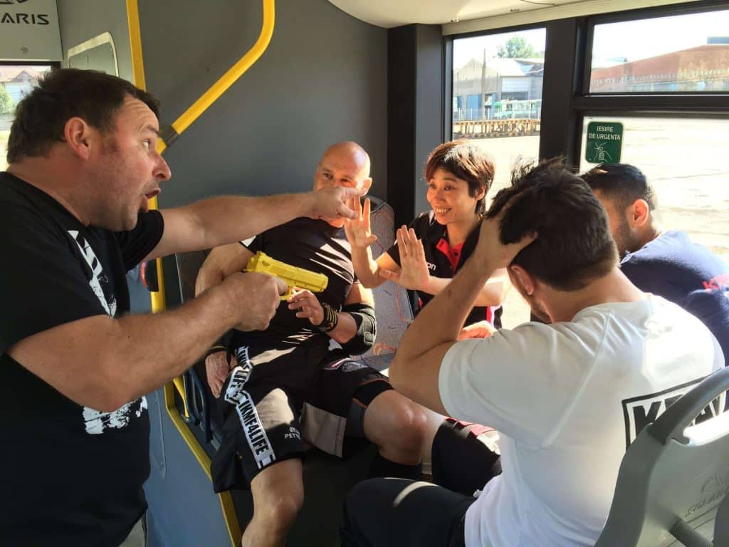 A group of people on an Xtreme Krav Maga Romania retreat sitting on a bus.